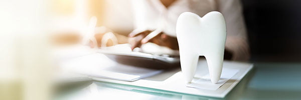 Dentist explaining all-on-4 dental implants cost and treatment plan to a patient in Vaughan