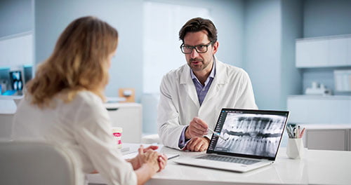 Dental consultation explaining the all-on-4 implant process to a patient