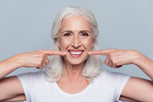 Candidate for full mouth dental implants showing a healthy smile and restored teeth