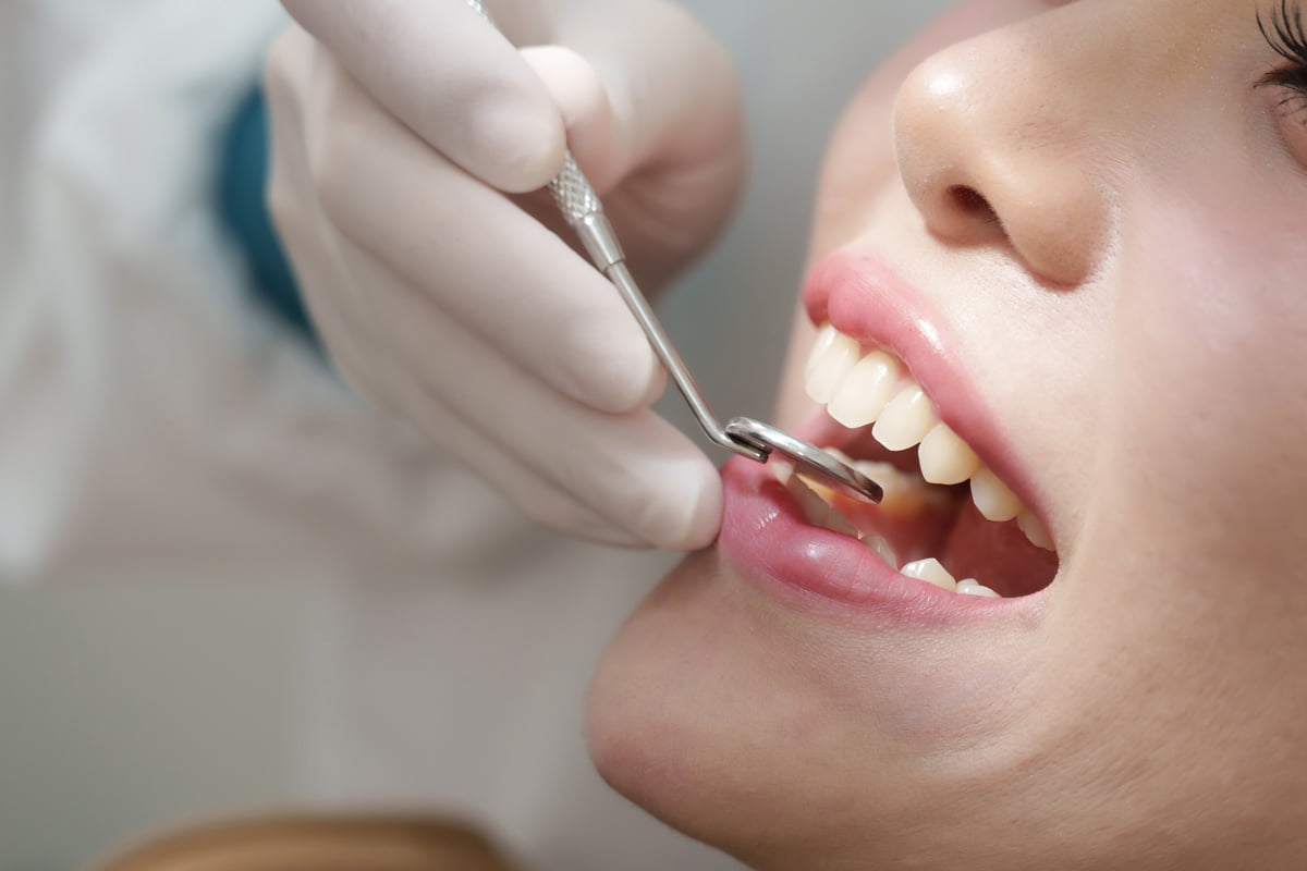 Dentist performing a cosmetic dental procedure on a patient in a modern dental clinic