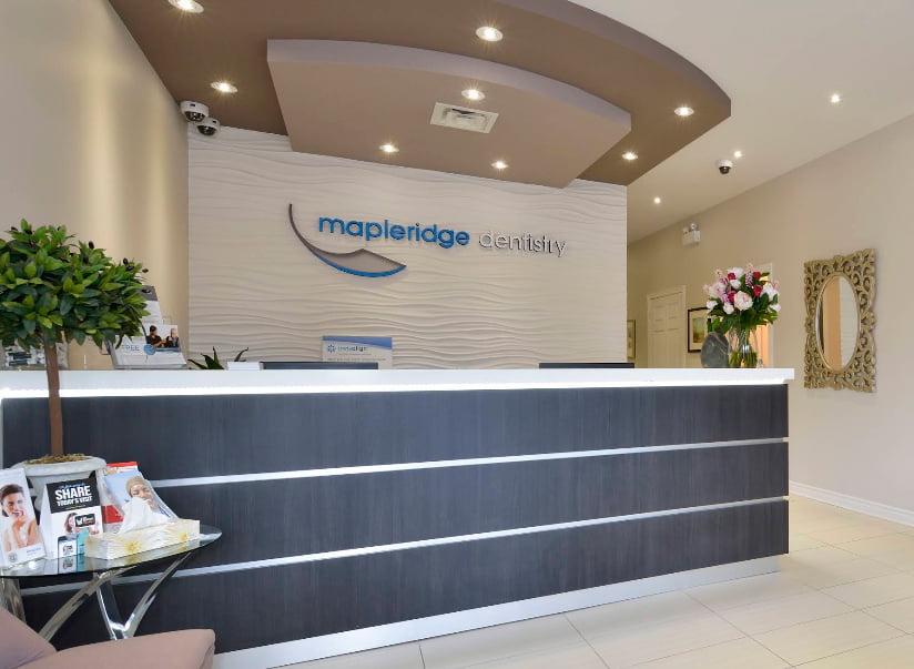 Modern reception area at Mapleridge Dentistry with welcoming front desk, contemporary interior design, and comfortable patient waiting space in Maple, Ontario