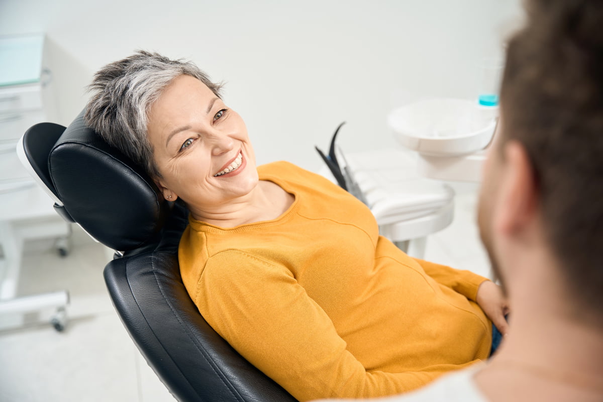Mature woman consulting with a dentist during a preventive dental care appointment