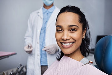 Patient showing a bright smile after a professional Zoom in-office whitening treatment