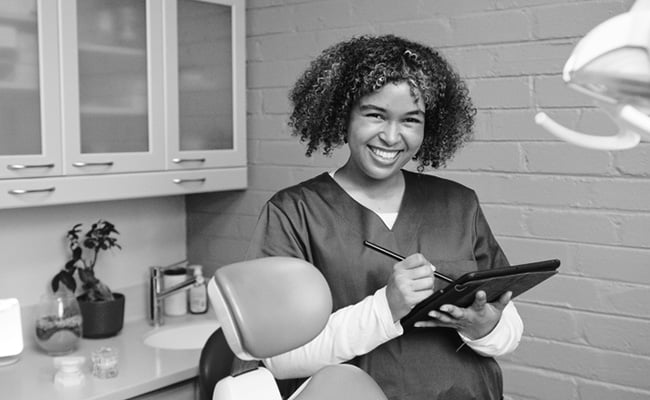 Dental professional using digital technology to plan and create a same-day CEREC dental restoration.