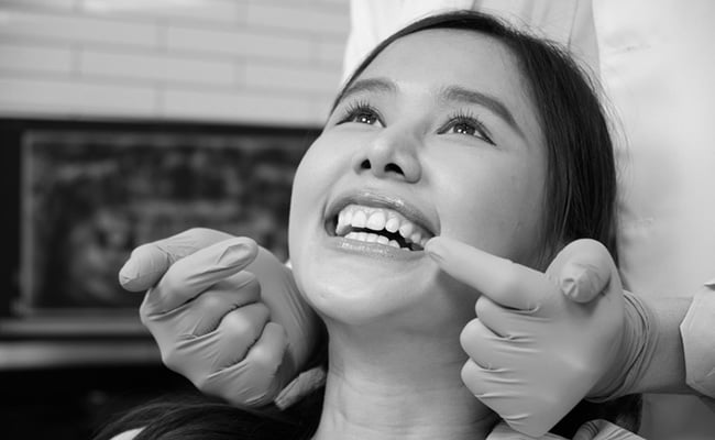 Patient showing a healthy, confident smile after receiving a dental crown restoration.
