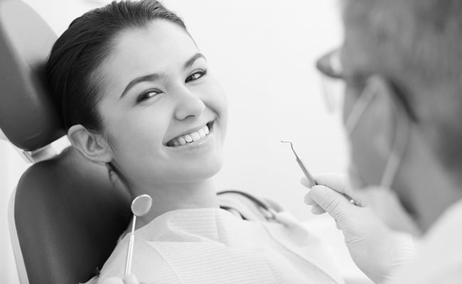 Happy patient after receiving non-surgical gum therapy to improve gum health and reduce inflammation.