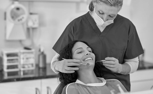 Dentist performing a preventive dental examination to help maintain long-term oral health.