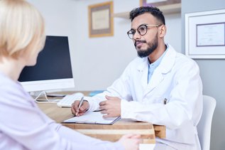 Dentist discussing the Canadian Dental Care Plan with a patient during a consultation in a modern dental clinic in Maple and Vaughan