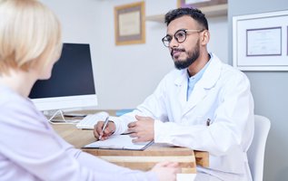 Dentist discussing the Canadian Dental Care Plan with a patient during a consultation in a modern dental clinic in Maple and Vaughan