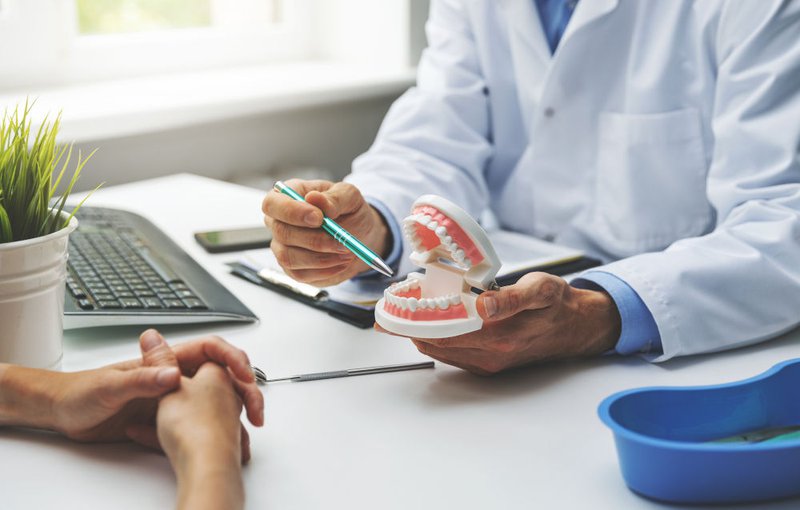 Dentist and Patient Discussing Planned Teeth and Gum Treatment