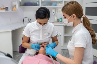 Dentist examining a patient's tooth for signs of a cavity