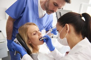 Young woman receiving root canal treatment at a dental clinic