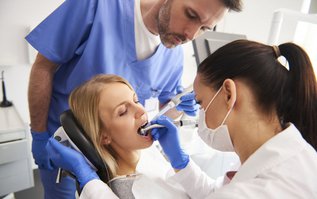 Young woman receiving root canal treatment at a dental clinic